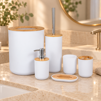 White six-piece bamboo bathroom accessories set on a warm stone vanity with soft natural lighting, open-top bin, metal soap pump and toilet brush